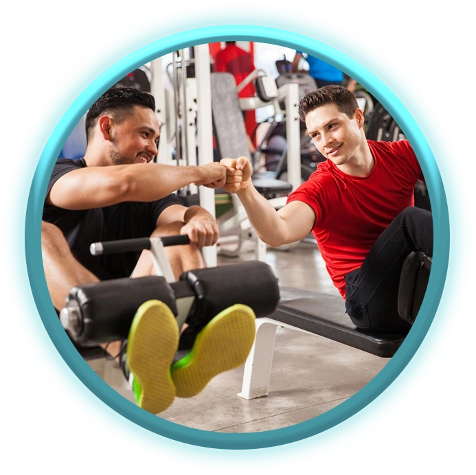 Two men are sitting on a bench in the gym.